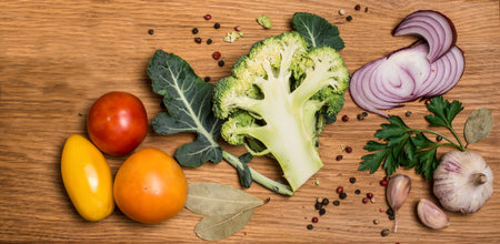 Bunch of fresh green broccoli on wooden background.  Fresh broccoli, cut into halves with ingredients for cooking, close up. Vegan food , vegetarian and healthily cooking concept.の写真素材