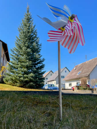 Colorful pinwheel with houses in the backgroundの写真素材