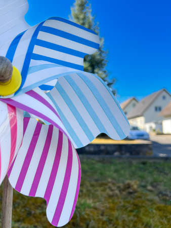 Colorful pinwheel with houses in the backgroundの写真素材