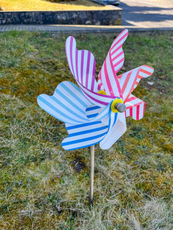 Colorful pinwheel with houses in the backgroundの写真素材