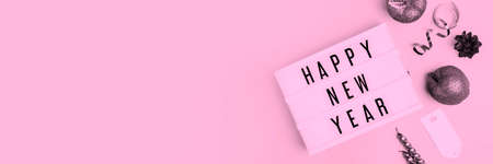 Happy New Year Text Light Box. Panorama Banner. Goodbye 2020 Concept Wide Angle Image On Pink Background. Abstract Celebration Concept With Copy Space For Message.の写真素材