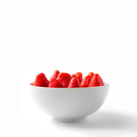 Strawberry In White Bowl Front View. Strawberries In White Plate Close-up Isolated On White Background. Organic Fruit Salad From Local Farm Market.の写真素材