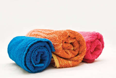Three colour towels on a white fabricの写真素材