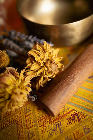 Close up of a flower petal on wood stick in a Tibetan bowlの写真素材