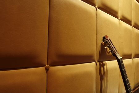 an acoustic guitar with a simple background at nightの写真素材