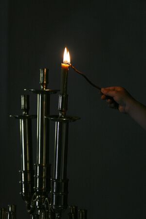a lighted candle in a churchの写真素材
