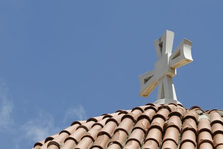 a simple frame with cross , roof and blue skyの写真素材