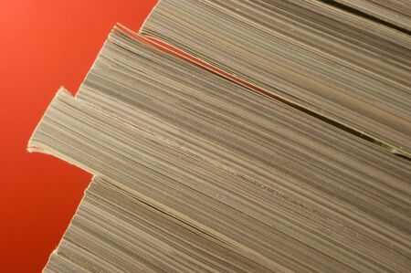 a close up frame with magazines in a red backgroundの写真素材