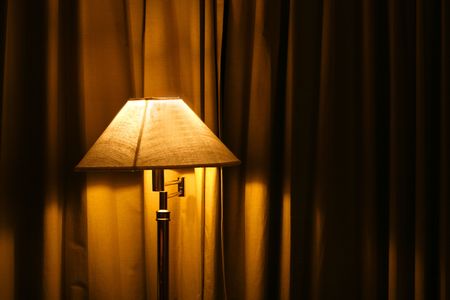  an open  standing lamp in a bedroomの写真素材