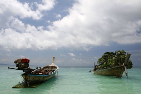 fishing boats in a small island at Puckett in Thailandの写真素材