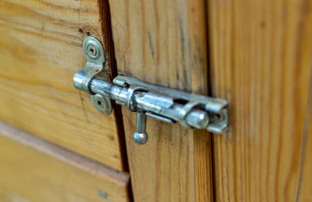 Vintage metal latch for a wooden door.の写真素材