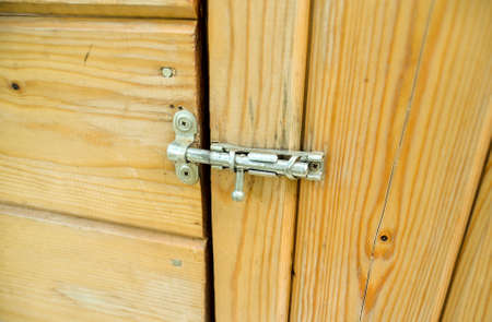 Vintage metal latch for a wooden door.の写真素材