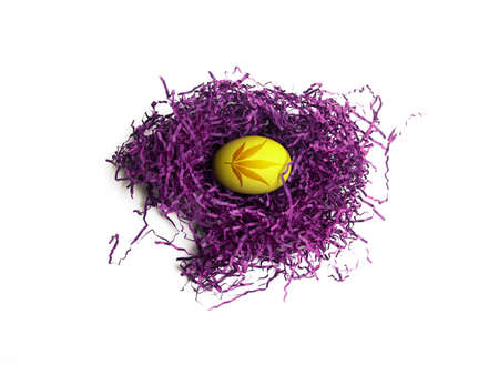 Easter egg with cannabis leaf pattern. Yellow egg in purple nestの写真素材