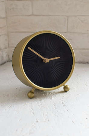 minimalistic watch with black dial and gold case and gold hands