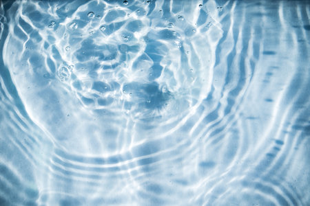 Water surface with ripples in blue tone. Abstract background and texture for design.の写真素材