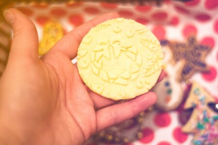 Beautiful round Christmas cookies with a pattern on a red-white background.