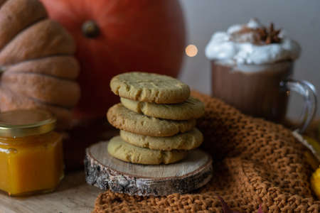 A stack of delicious homemade almond biscuits with a cup of cocoa with whipped cream. Autumn...