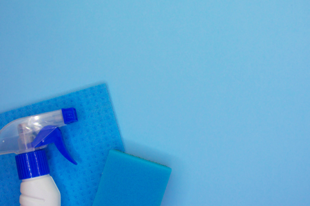 Detergents and cleaning accessories in blue color. Cleaning service, small business idea. Flat lay, Top view.の写真素材