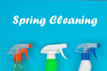 Colorful cleaning set for different surfaces in kitchen, bathroom and other rooms. Empty place for text on blue background. Cleaning service concept. Early spring regular clean up. Top view.の写真素材