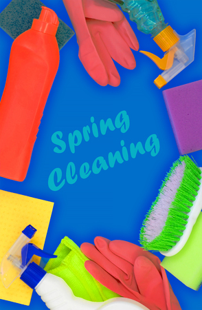 Colorful cleaning set for different surfaces in kitchen, bathroom and other rooms. Empty place for text on blue background. Cleaning service concept. Early spring regular clean up. Top view.の写真素材