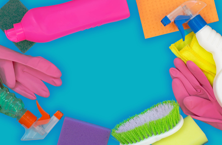 Colorful cleaning set for different surfaces in kitchen, bathroom and other rooms. Empty place for text on blue background. Cleaning service concept. Early spring regular clean up. Top view.の写真素材