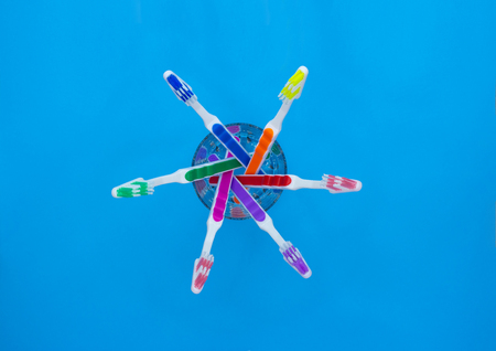 Toothbrushes in a glass, blue background. Top viewの写真素材