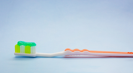 Dental brush with toothpaste on blue background.の写真素材