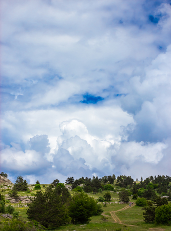Colorful summer landscape in the mountains, under a blue sky with white cloudsの写真素材