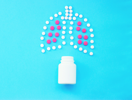 Lungs made of pills on blue background.の写真素材