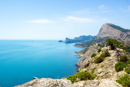 The view from the heights of the mountains, the sea and the blue sky with white clouds. Summer landscape in Crimea.の写真素材