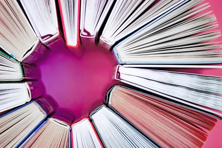 The heart of books on pink background. Top view. Love conceptの写真素材