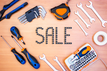 Inscription sale in the frame made of construction tools, such as screwdrivers, wrenches, tape...