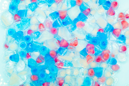 Background with transparent, white, pink and blue ice cubes. Fresh summer pattern. Flat Lay. Top viewの写真素材