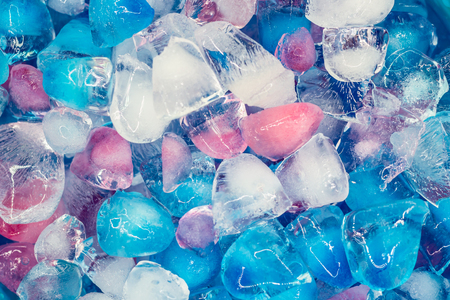 Background with transparent, white, pink and blue ice cubes. Fresh summer pattern. Flat Lay. Top viewの写真素材