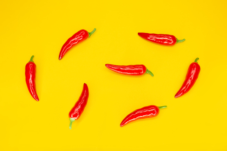 Red chilli peppers on yellow background. Ingredient of Mexican Cuisine. Flat lay. Top viewの写真素材