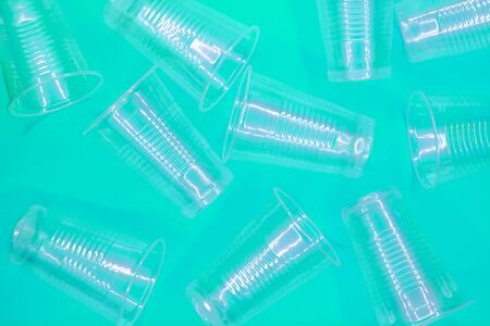 Disposable transparent plastic cups on a blue background. Recycling ecology concept. Top view. Flat lay.の写真素材