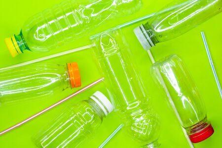 Empty plastic bottles and straws. Recycle waste concept. Top view. Flat layの写真素材