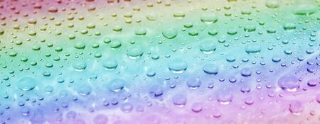 Rainbow water drops surface. Abstract summer background. Close-up view