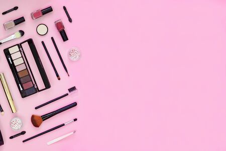 Makeup brush and decorative cosmetics on pink background with empty space. Top viewの写真素材