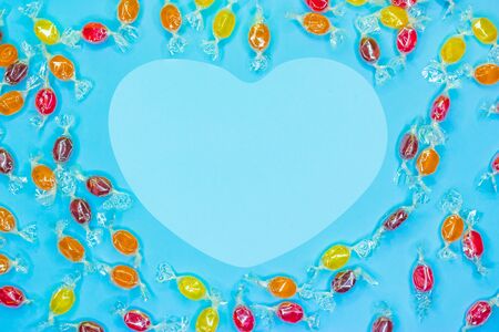 sweets in the shape of a heart on blue background with copy space. Top view.の写真素材