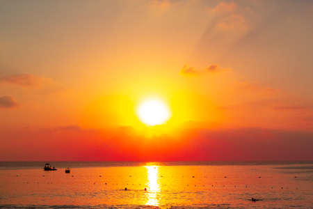 Beautiful orange sunset over the sea beachの写真素材