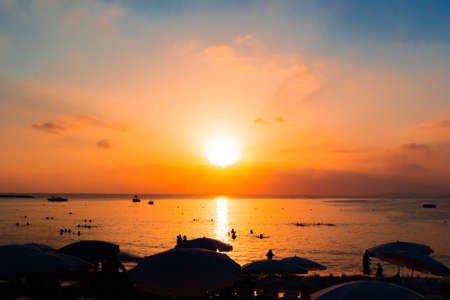 Beautiful orange sunset over the sea beachの写真素材