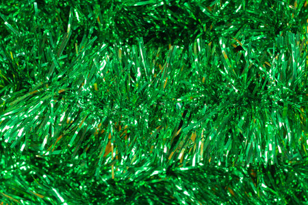 Green shiny Christmas tinsel close up. Christmas background with garland and copy spaceの写真素材