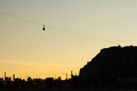 Overhead cable car on sunset. Trolley silhouette. Sunset photography. Ropeway.