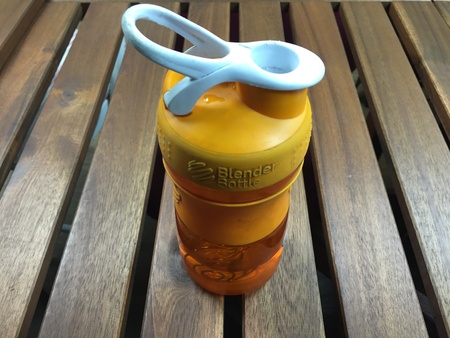 Orange bottle on the wood tableの素材