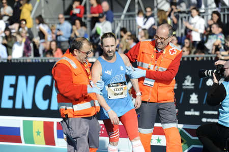 VALENCIA, SPAIN - 1 DECEMBER 2019: exhausted runner at the finish line of the Valencia 2019 marathon