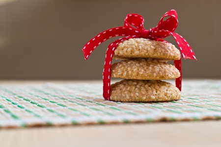 Homemade sesame seed cookies stacked with red striped bowの写真素材