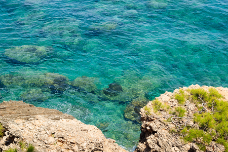 Crystal clear transparent turquoise water of Mediterranean sea near rocky shore in Turkey, Antalya regionの写真素材
