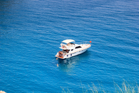 KEMER, TURKEY - MAY 2017: Tourists sailing recreationally on a motor boat anchored near shore.のeditorial素材