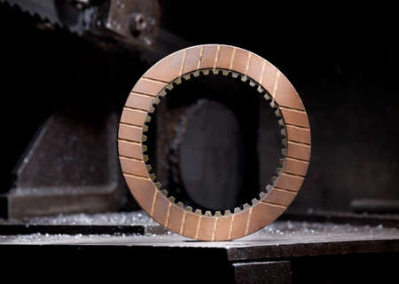 closeup of metallic cogwheel - mechanic steel detail on industrial backgroundの写真素材